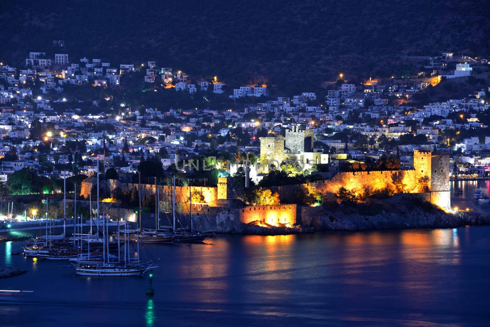 View of Bodrum harbor and Castle of St. Peter by night. Turkish Riviera.