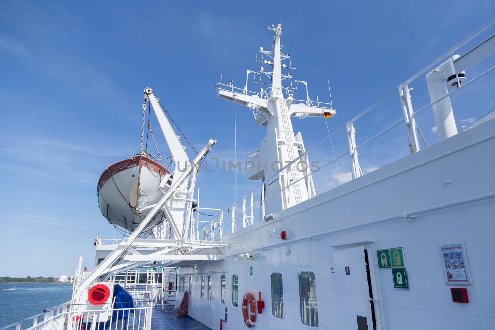 Ship deck with lifeboat and radar mast of a ferry