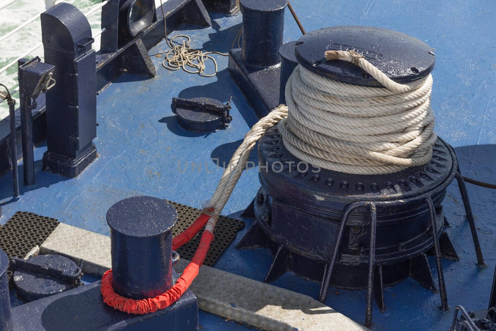 Winch,rope and bollard on deck of a large ship