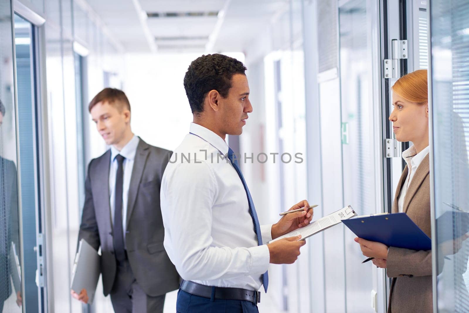 Young businessman consulting his colleague in office