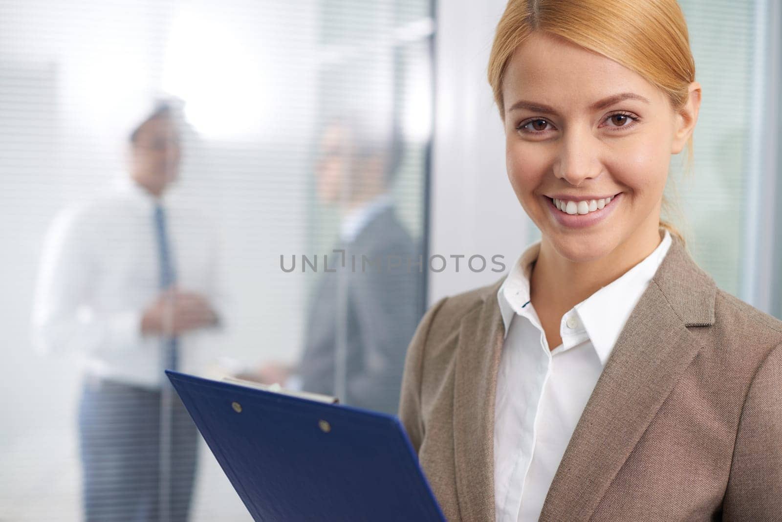 Pretty businesswoman looking at camera with smile
