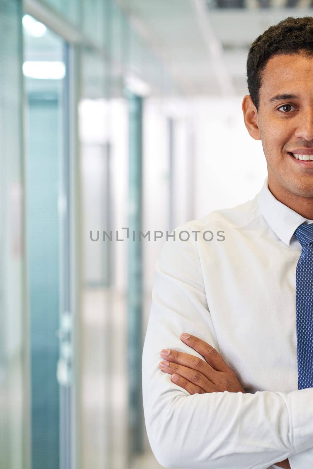 Elegant businessman with crossed arms looking at camera