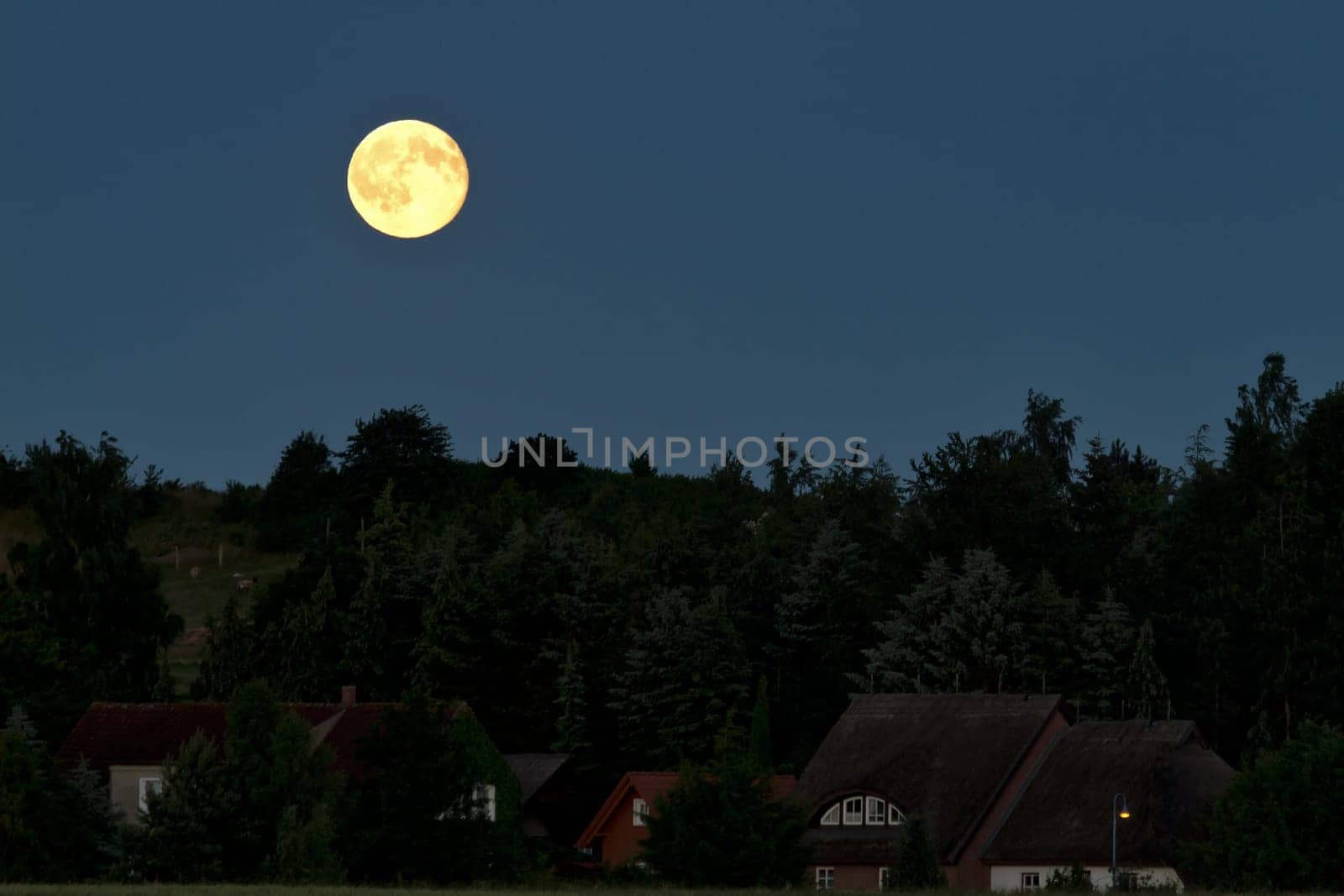 Full moon in the night sky over Alt Reddevitz/Mönchgut,island of Rügen