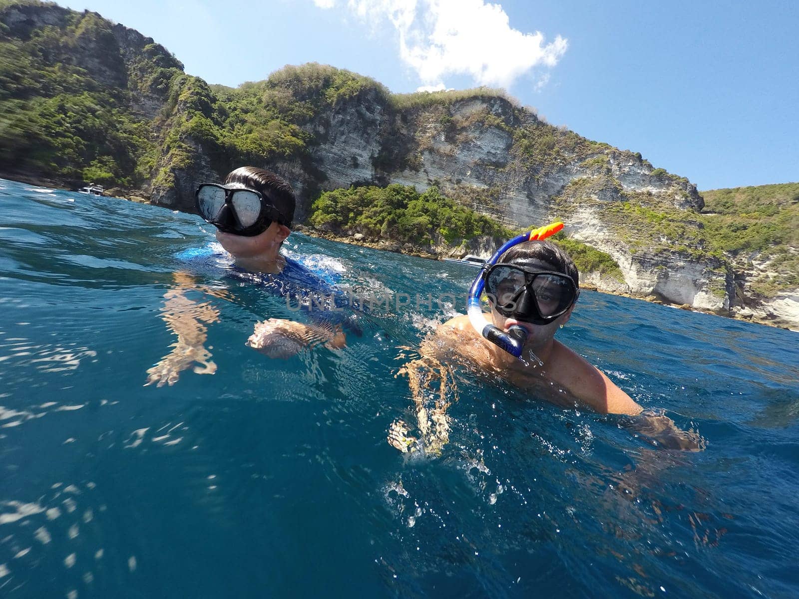 shoot of a young boy snorkeling with father