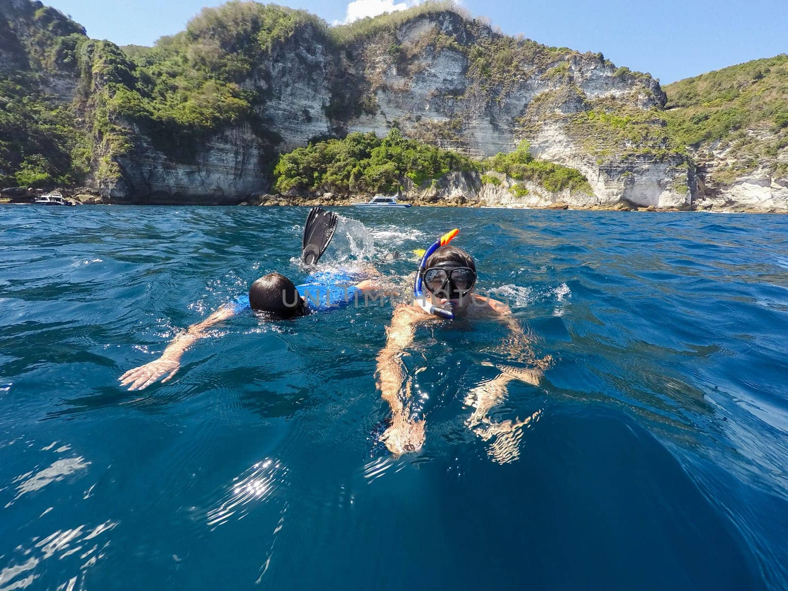 shoot of a young boy snorkeling with father