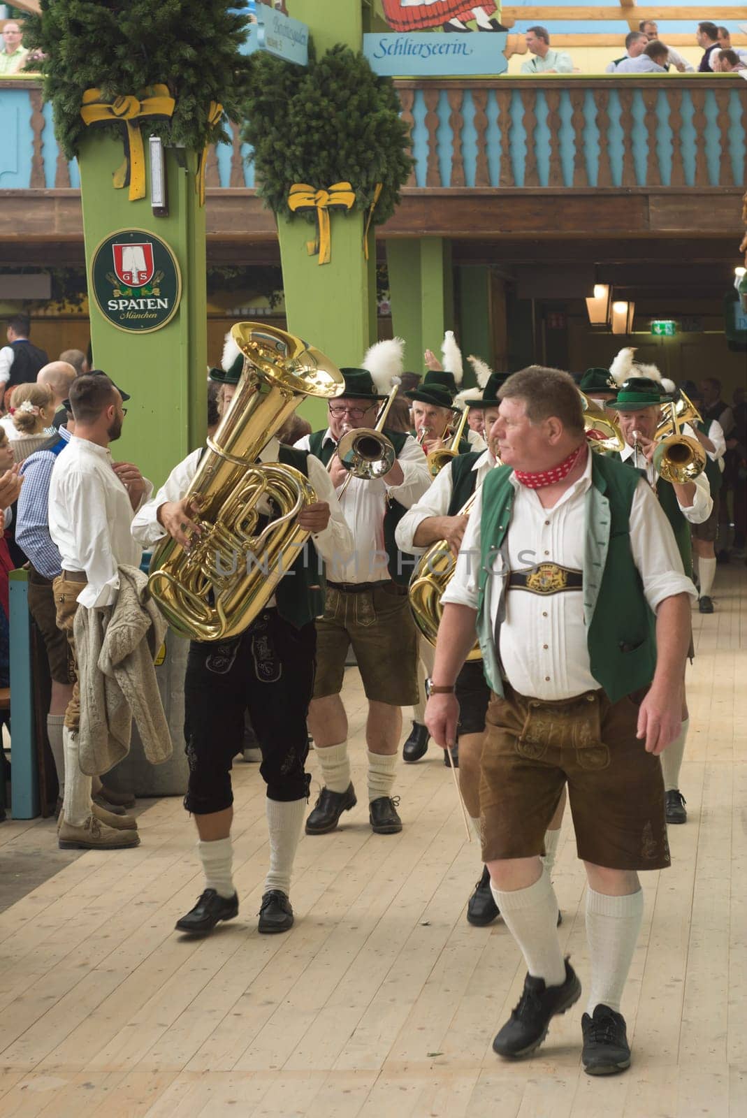 MUNICH, GERMANY – SEPT. 20, 2015: Traditional Marching Bands with Local Costumes entertain Crowds of visitors at the annual Oktoberfest. The Festival runs from September 19th until October 4th 2015 in Munich, Germany