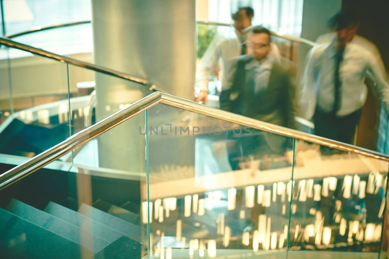 Blurred outlines of moving businessmen inside business center