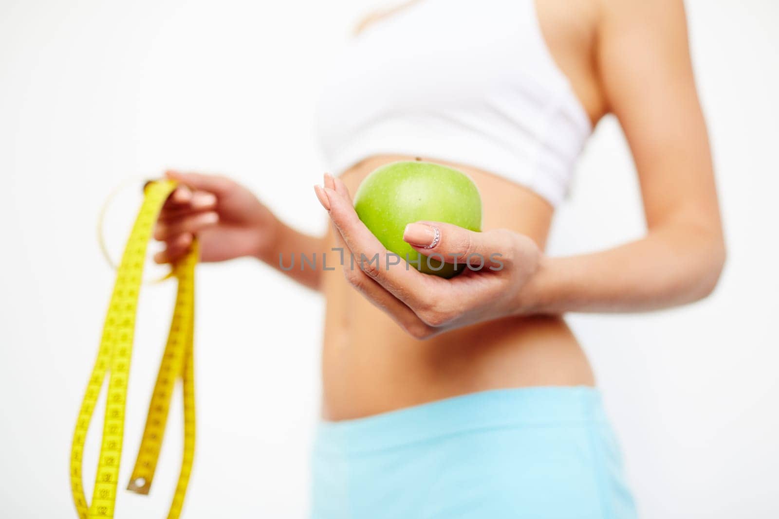 Slim female holding green apple
