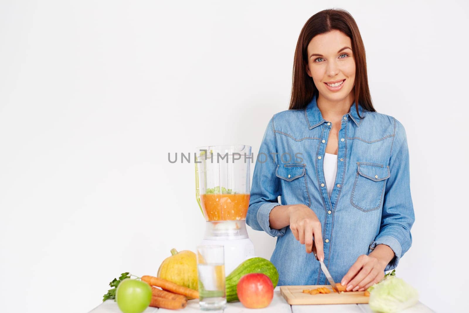 Pretty girl cutting ingredients for vegetable salad