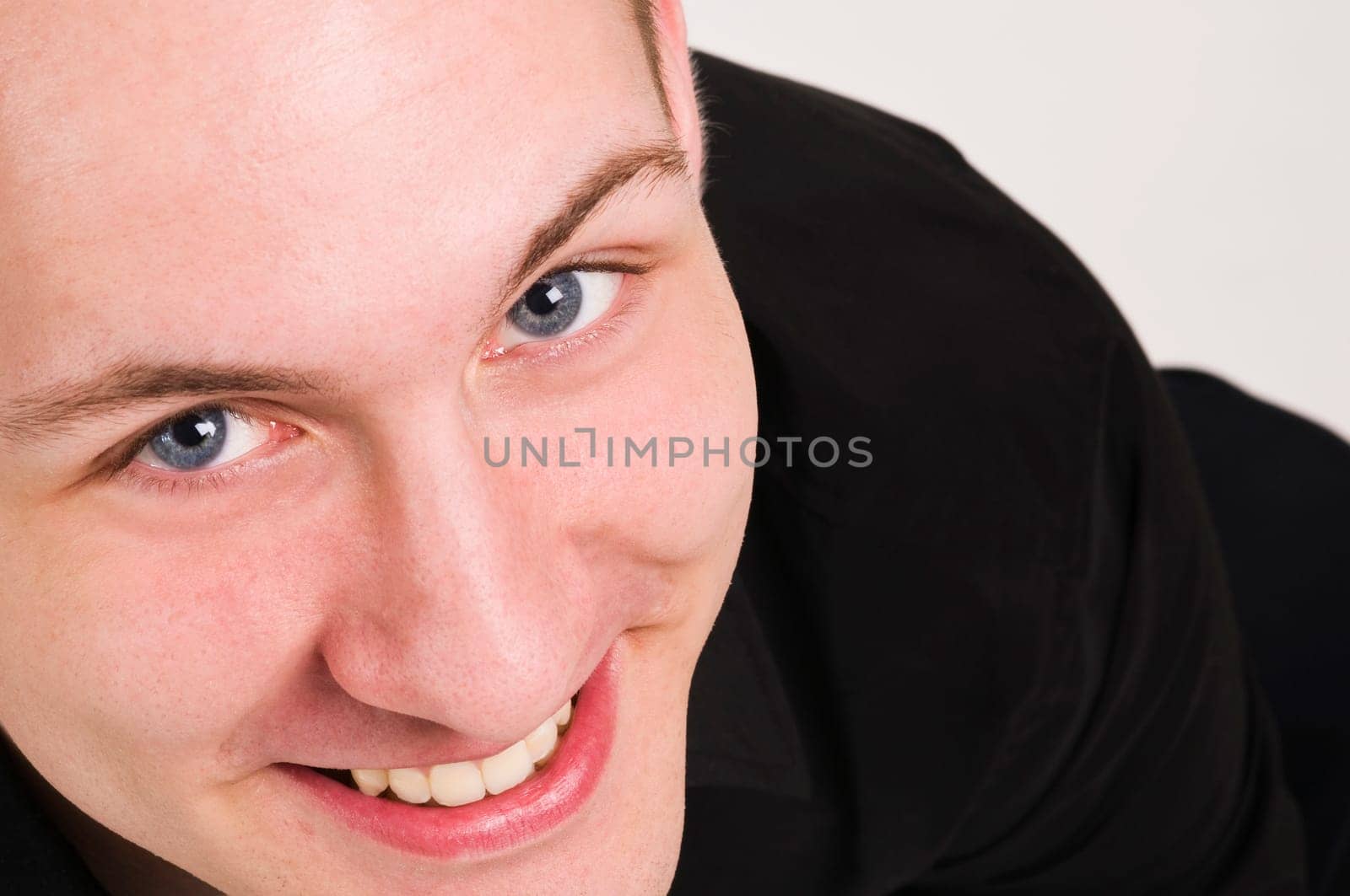 Closeup of a young man joyfully,looking up into the camera