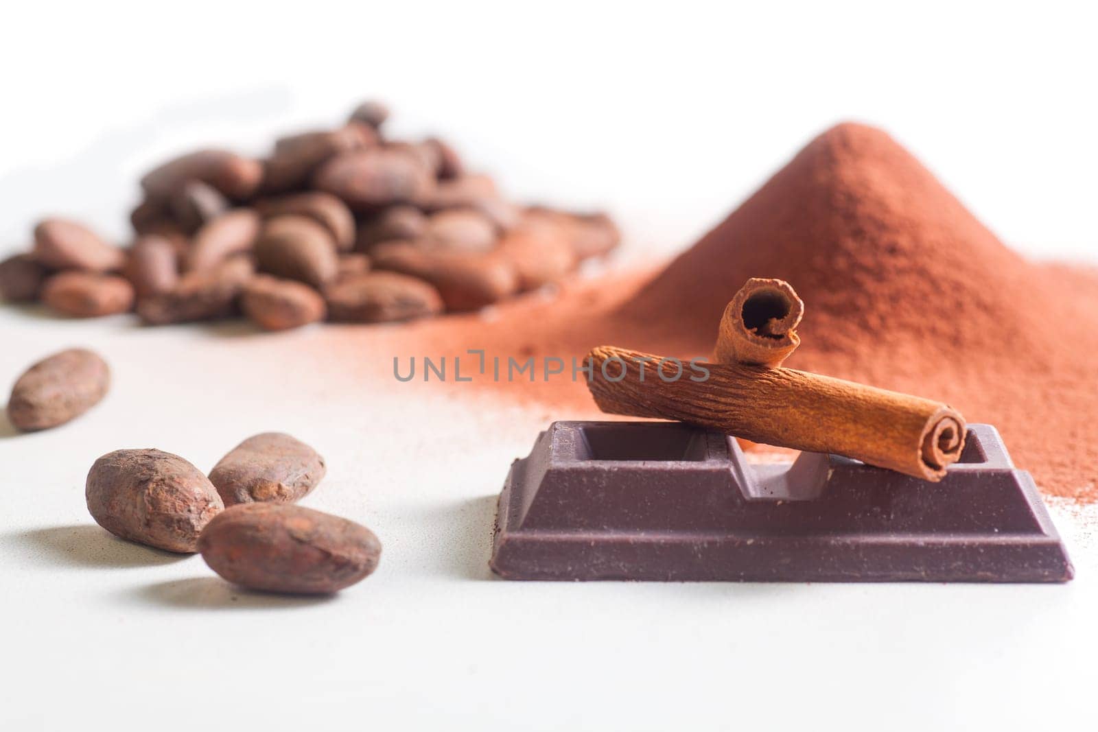 Close up of chocolate bar, cacao and cinnamon