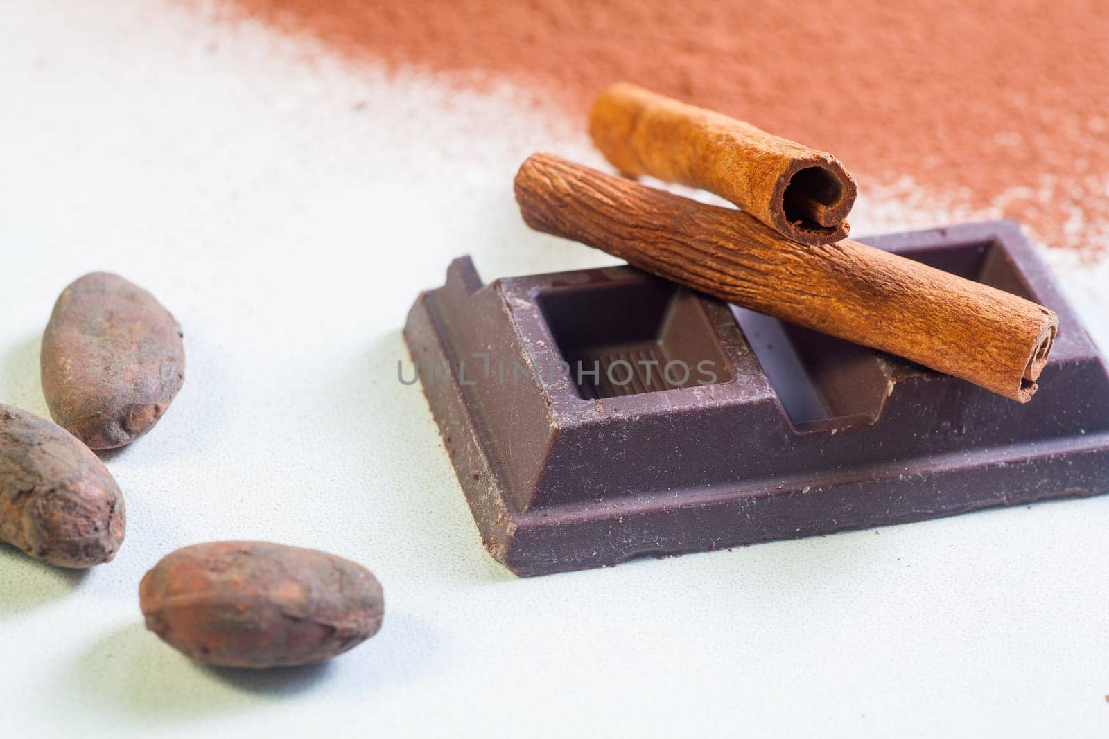 Close up of chocolate bar, cacao and cinnamon