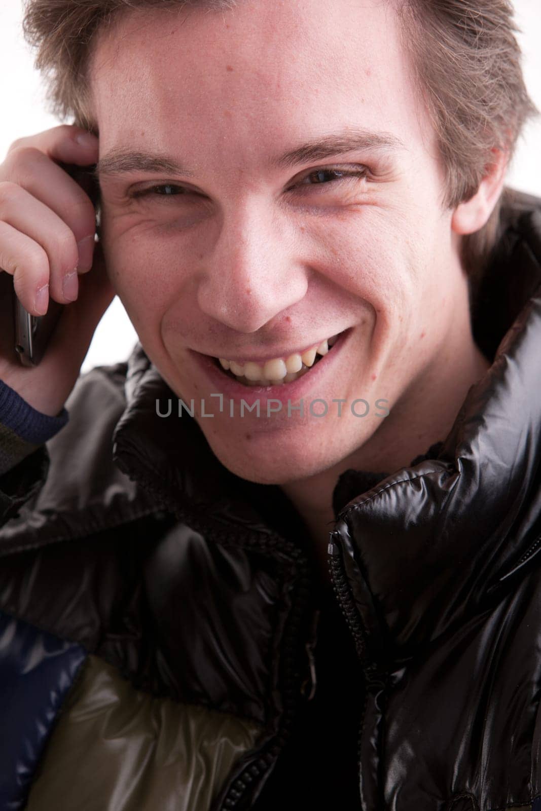 portrait oaf a goold looking young man phoning on a mobile phone