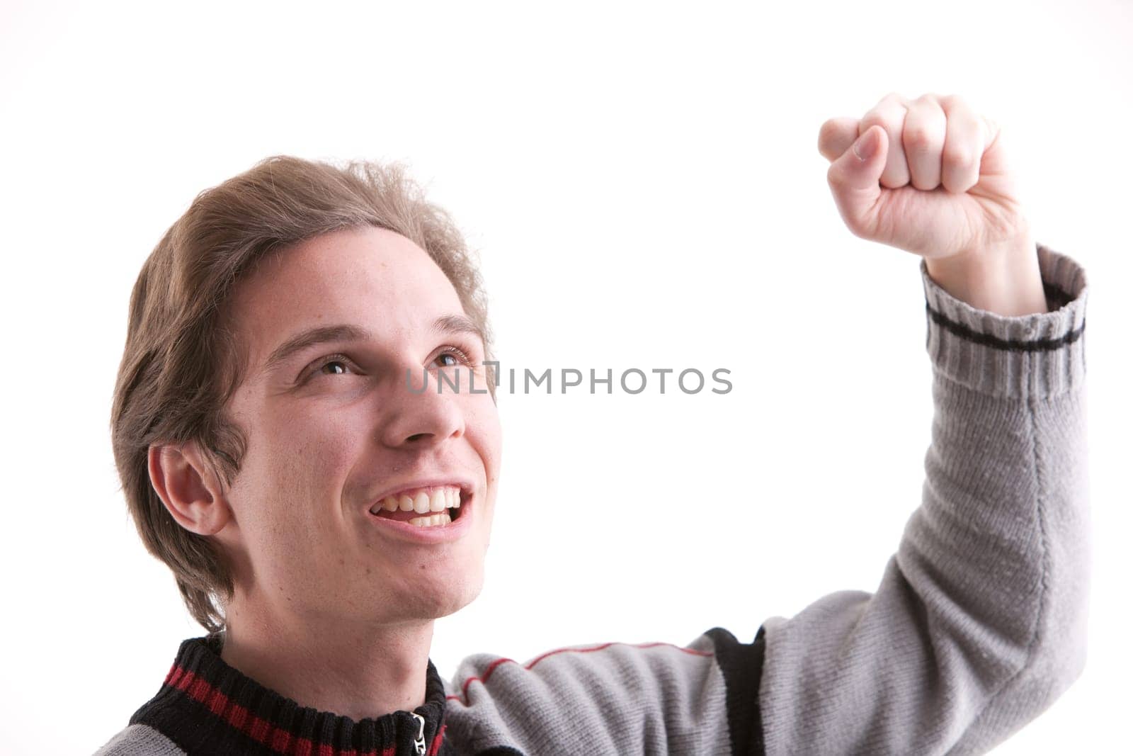 young man exulting while rising up his fist