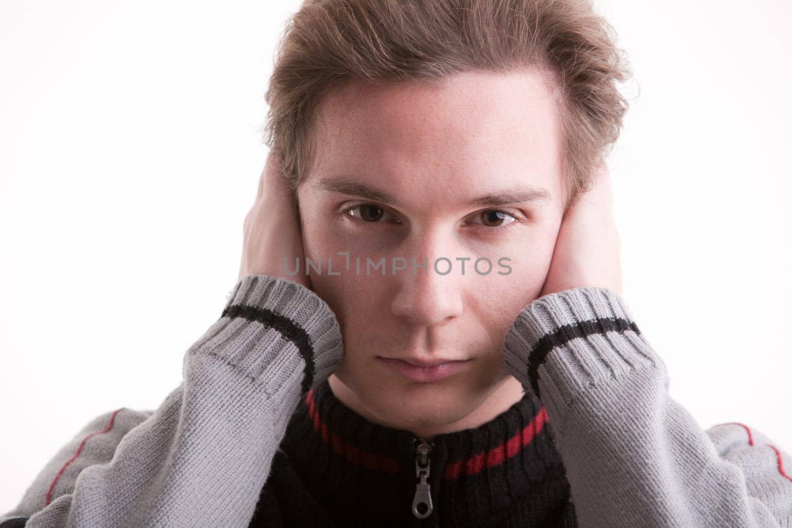 man covering ears with hands showing he can't ear