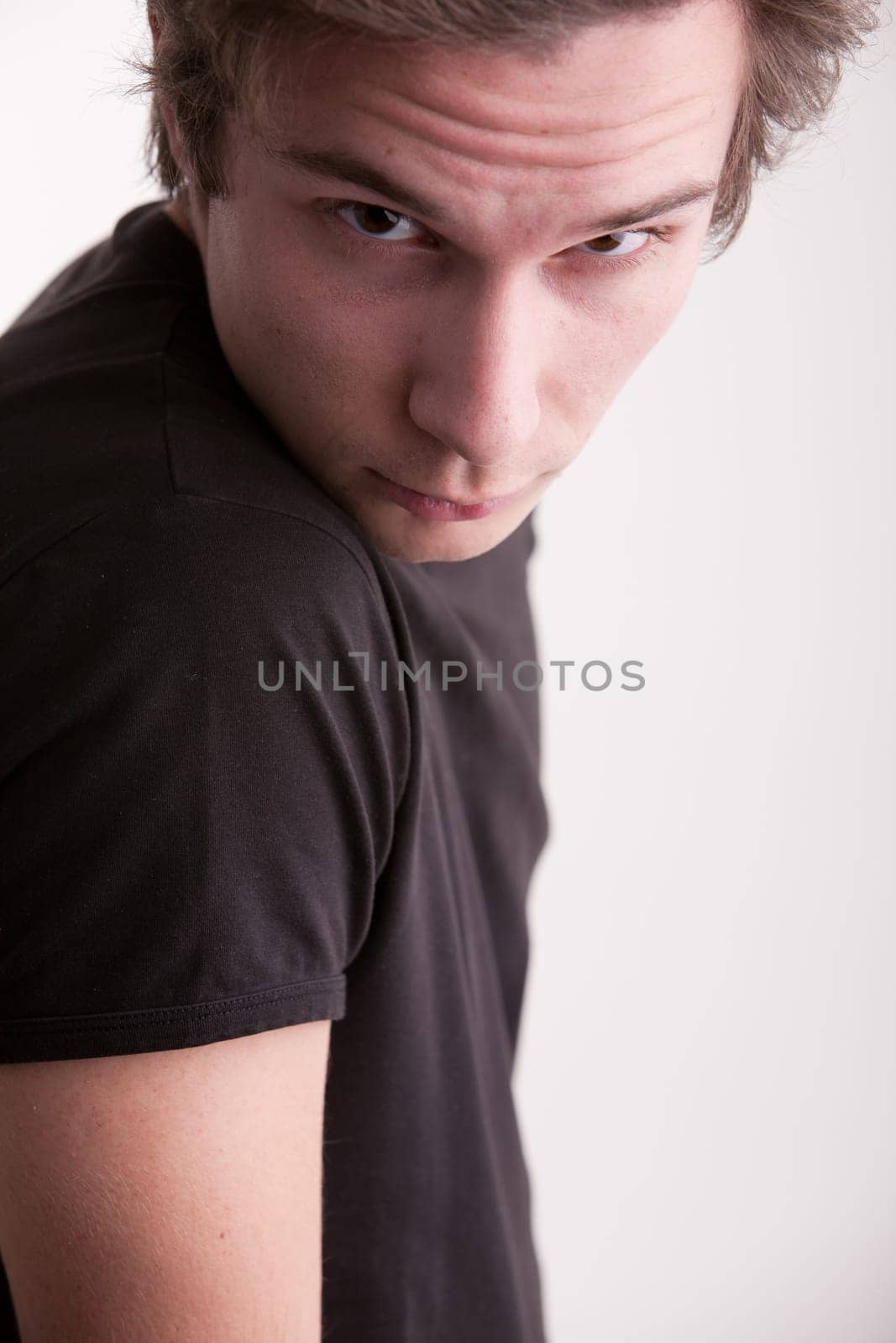 good looking young man looking intensely in camera like a fashion model does