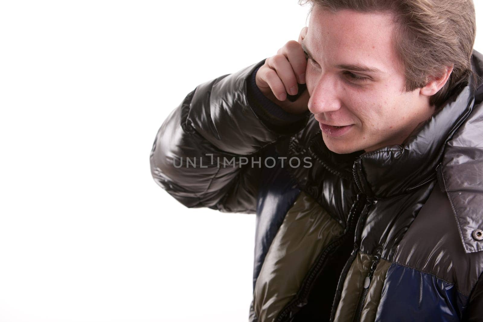 portrait oaf a goold looking young man phoning on a mobile phone
