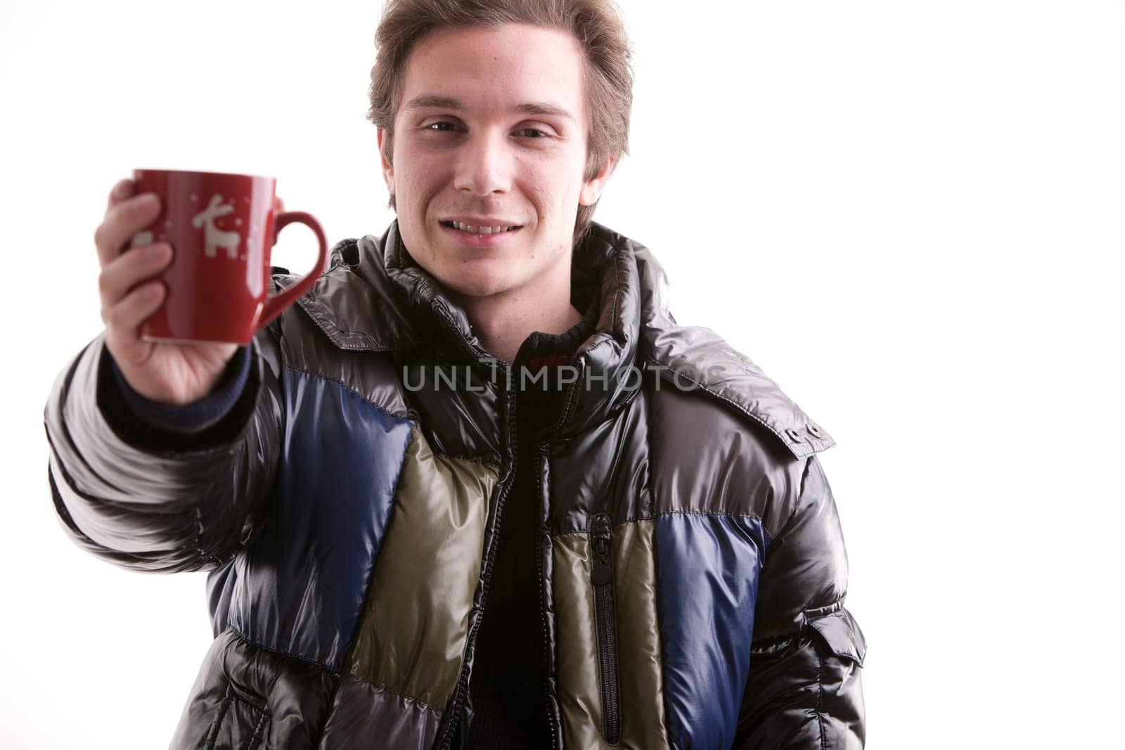 young man showing a red mug with christmas symbols
