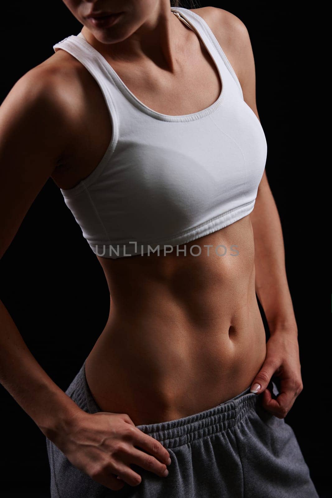 Fit female in sportswear posing in isolation