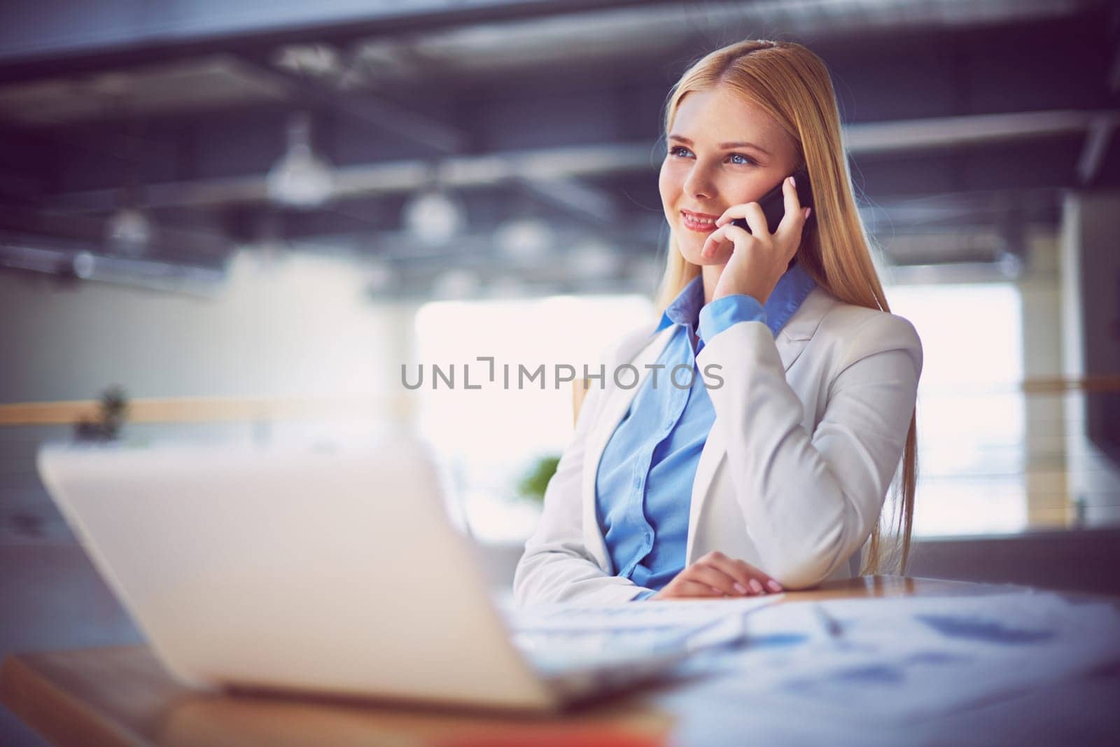 Young businesswoman talking on the phone during break