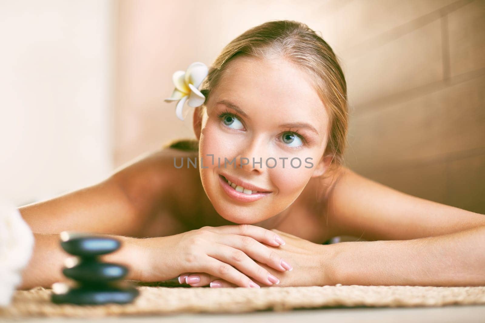 Smiling girl looking aside while relaxing in beauty salon