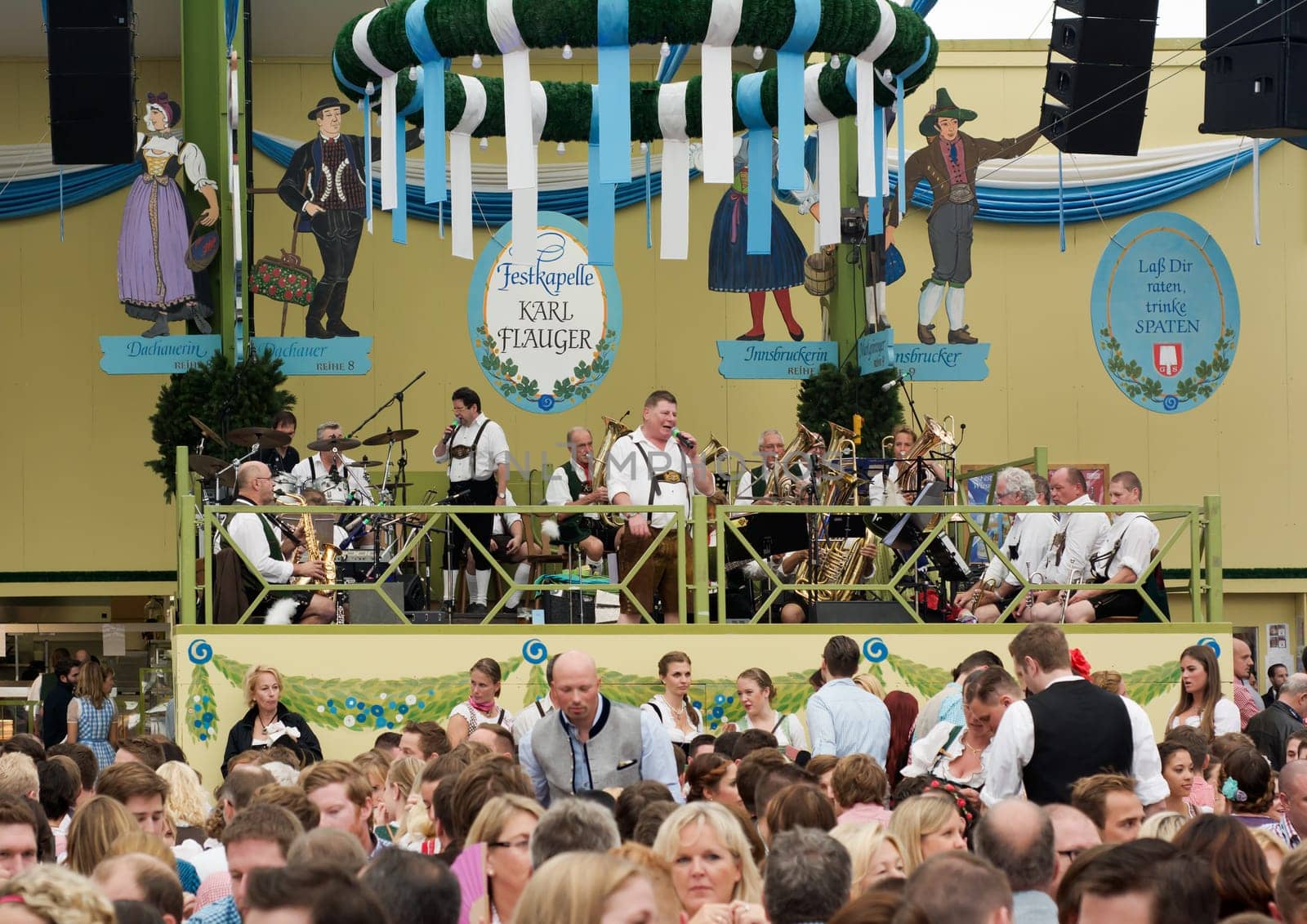 MUNICH, GERMANY – SEPT. 19, 2015: Oktoberfest Visitors Enjoy Traditional Music and Beer in the Spatenbrau Tent. The Festival runs from September 19th until October 4th 2015 in Munich, Germany.