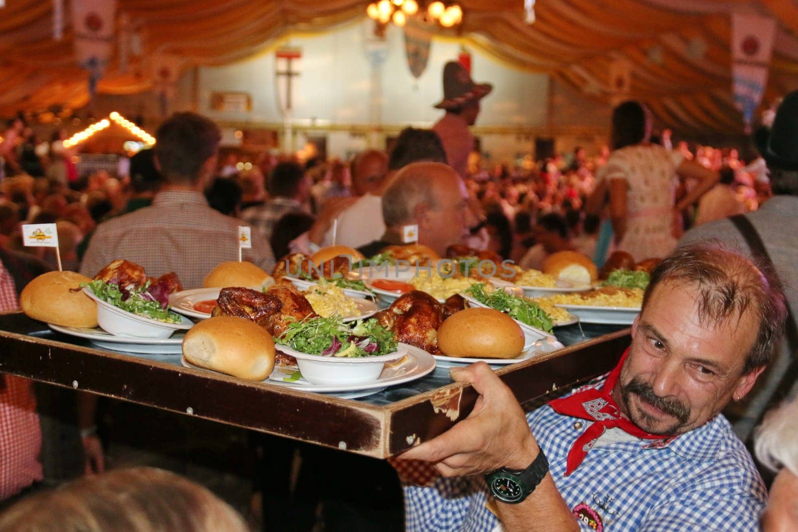 The waiters at Oktoberfest Konstanz 2015 have to do the schwest work until chicken,haxen and schnitzel are served.