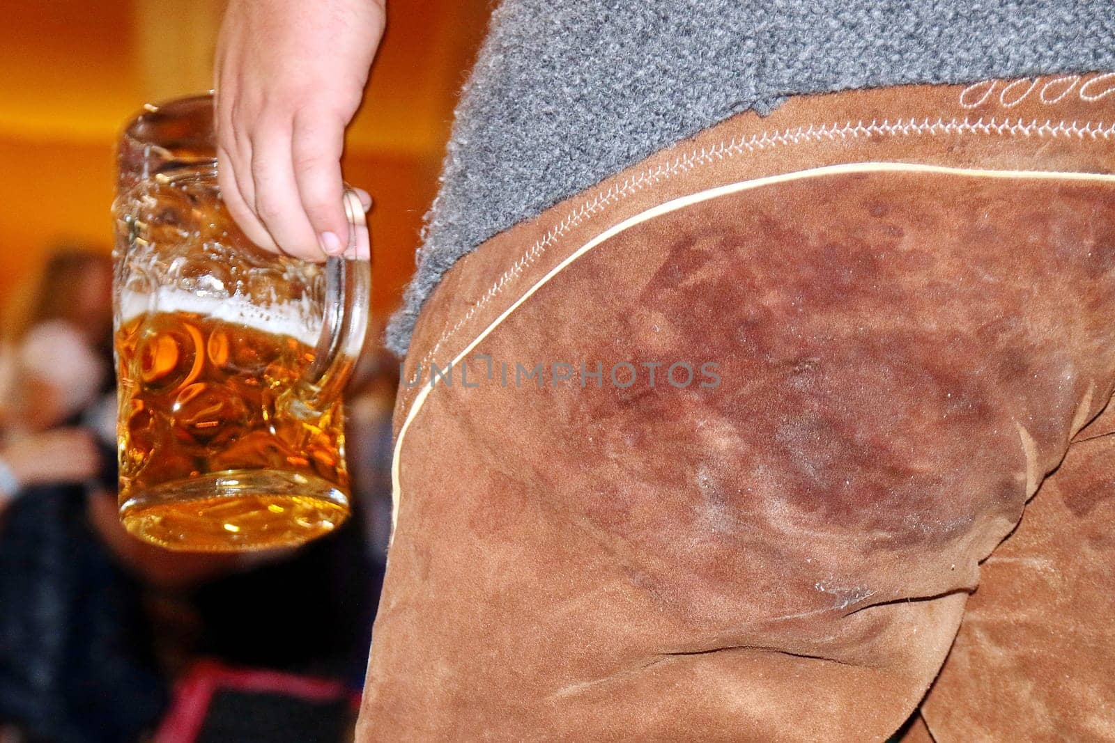 A measure of beer in hand,the leather trousers already light (marked - man at Oktoberfest Konstanz 2015