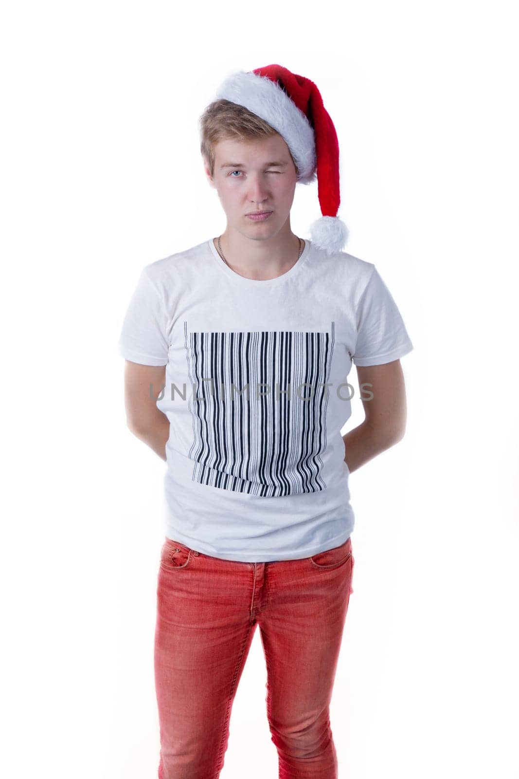 holiday portrait with a young caucasian male wearing a santa hat over a white background