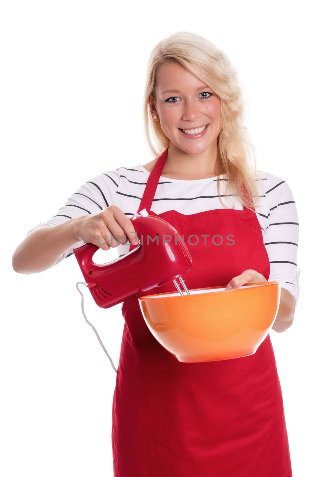 Woman in apron stirs with a blender in a bowl