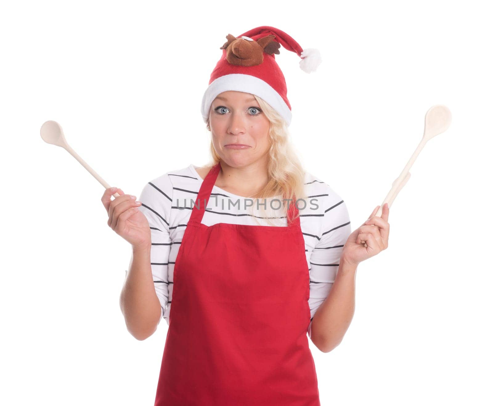 Christmas woman with cooking spoons looks skeptical
