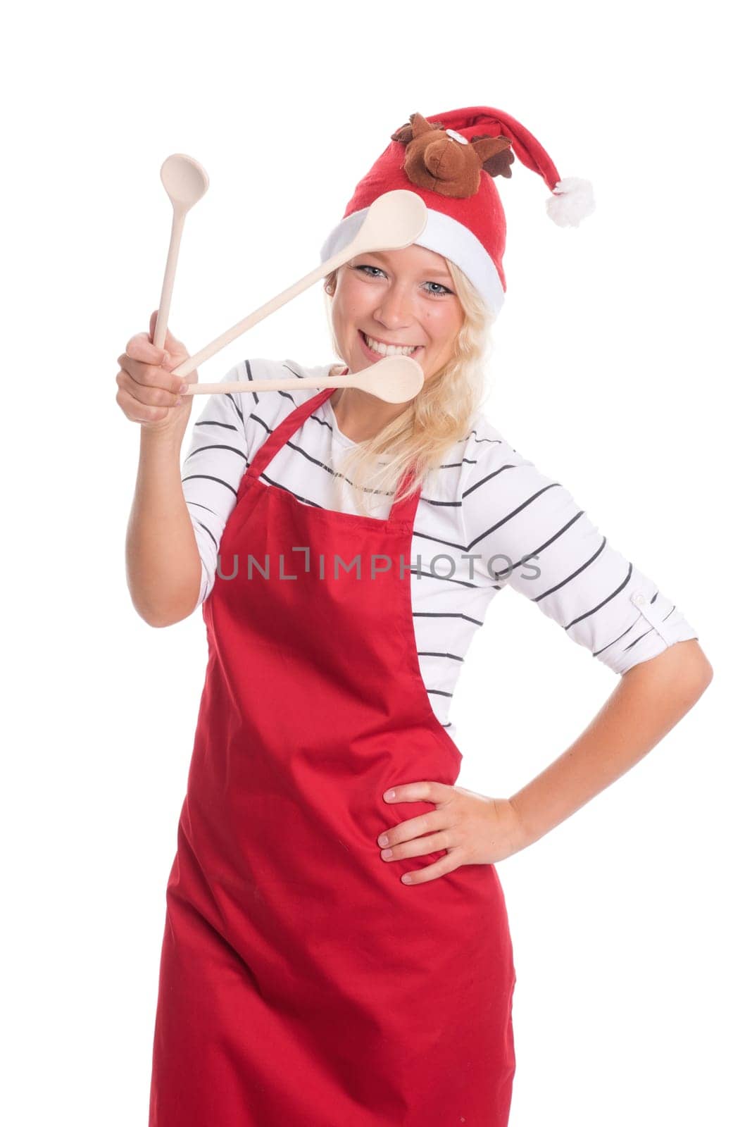 Christmas woman with kitchen apron shows three cooking spoons
