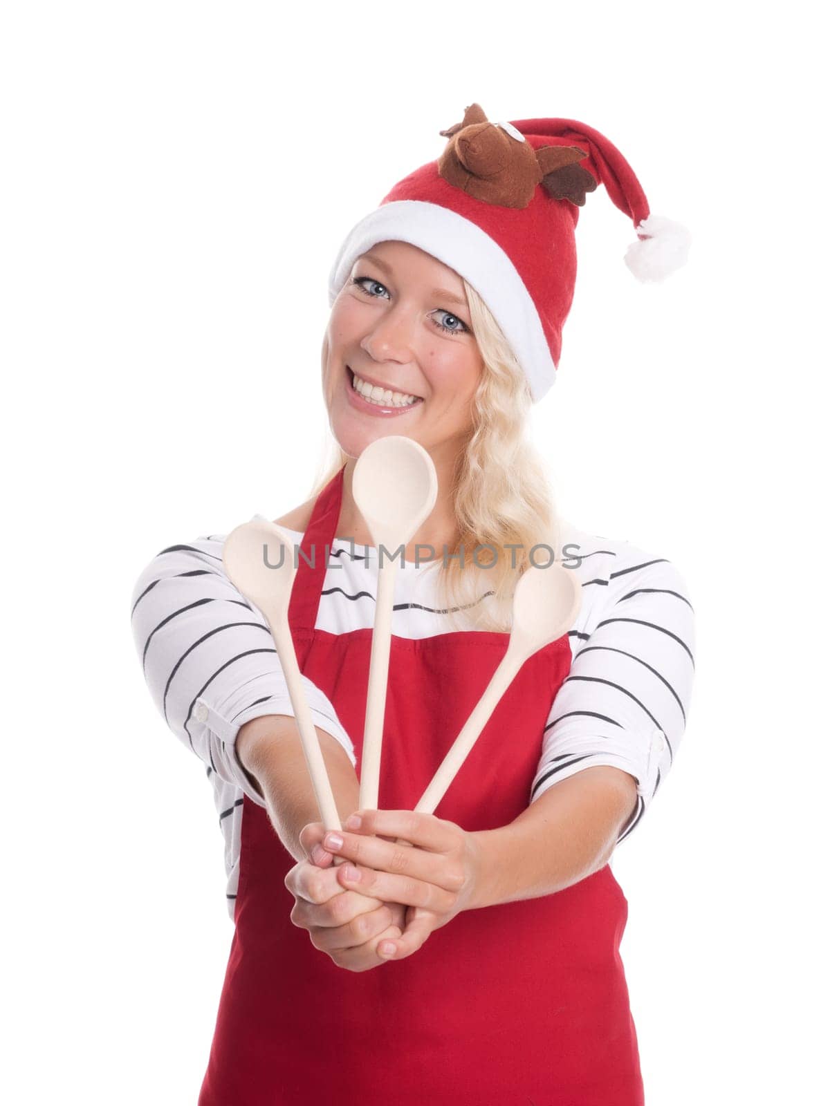 Christmas woman with kitchen apron shows three cooking spoons