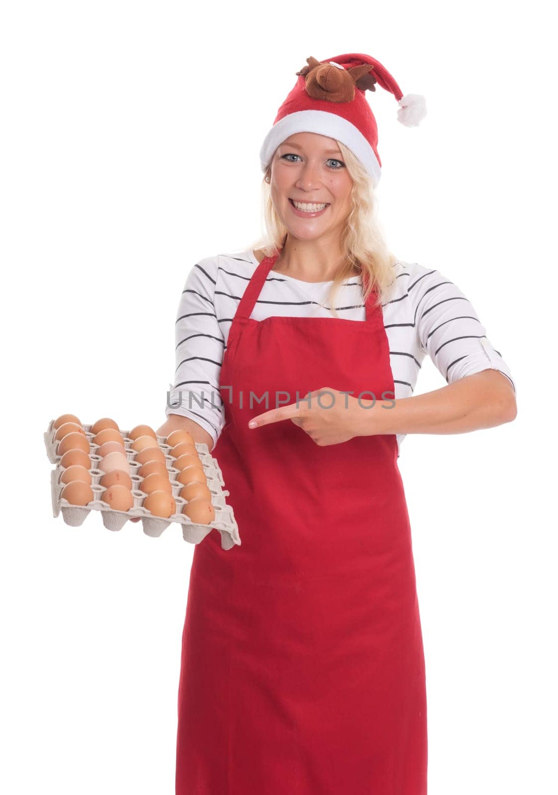 Woman with Christmas hat and apron holds a palette of eggs