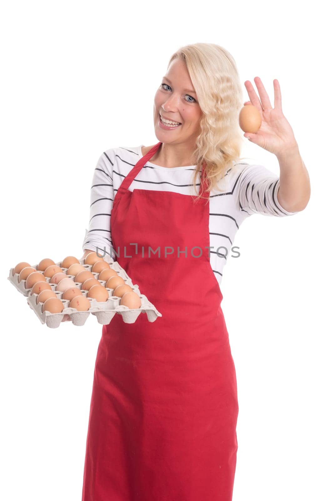 Woman with apron holds an egg palette and shows an egg