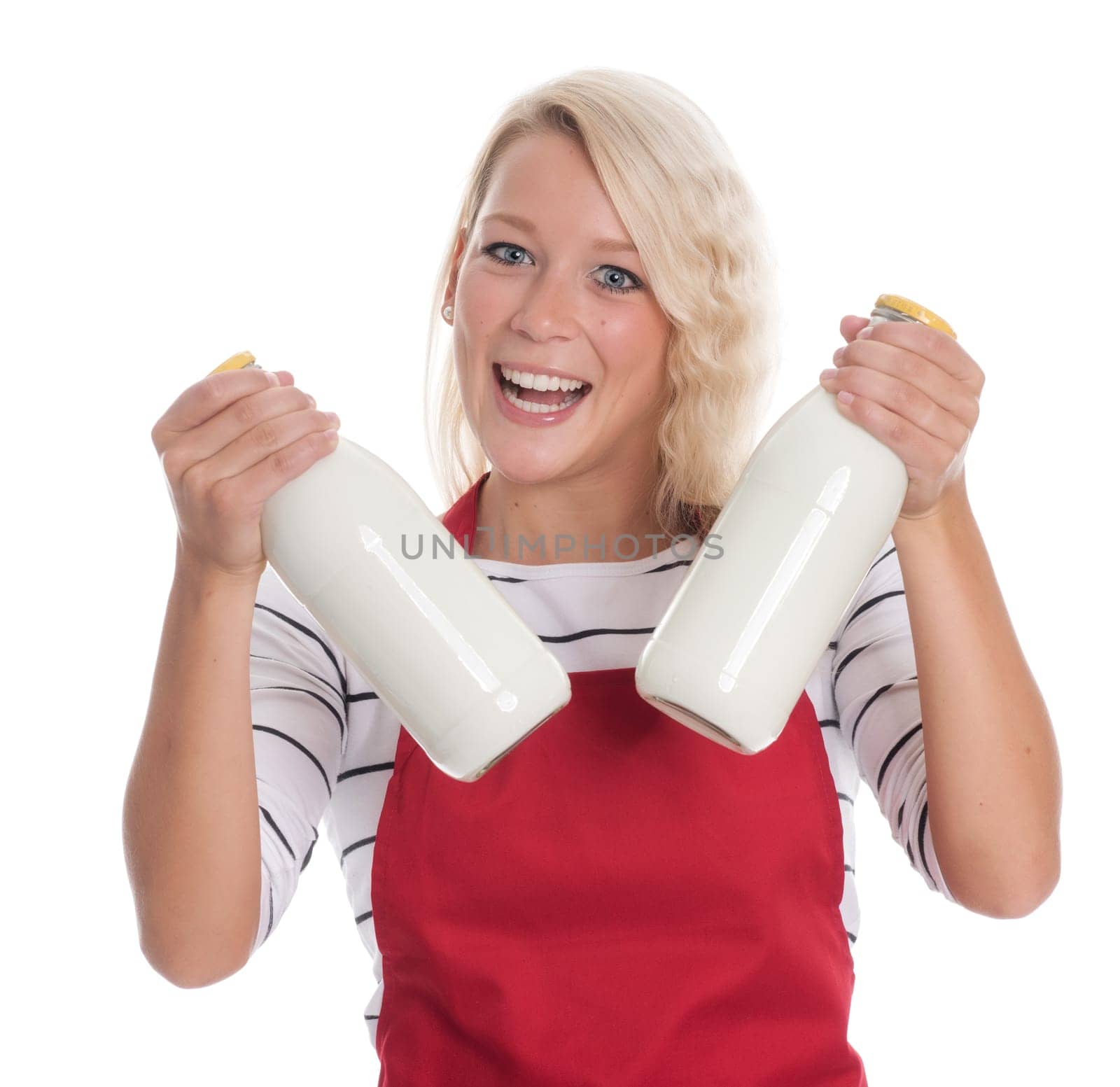 Housewife in red apron holds two bottles of milk