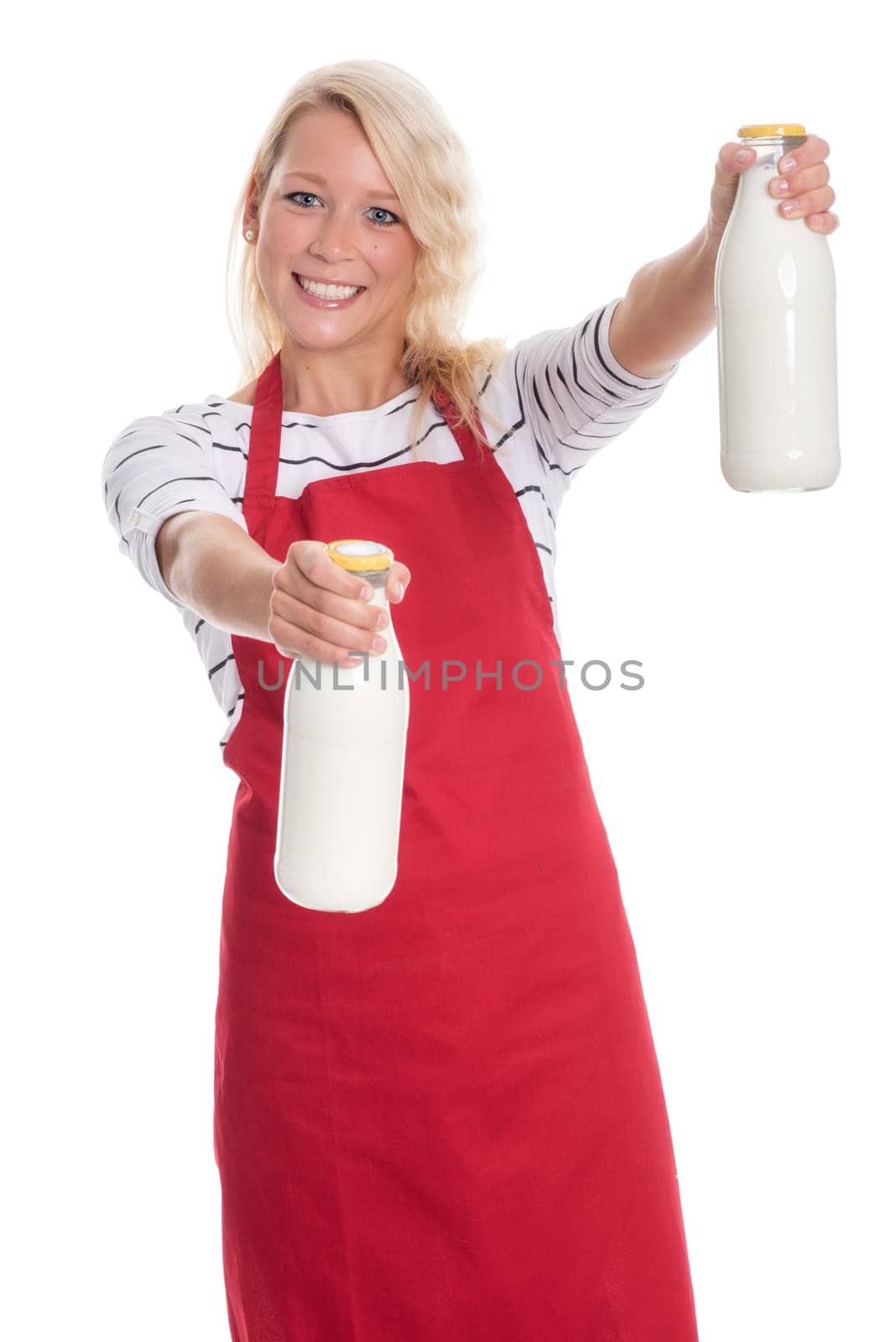 Woman in kitchen apron holds two litres of milk
