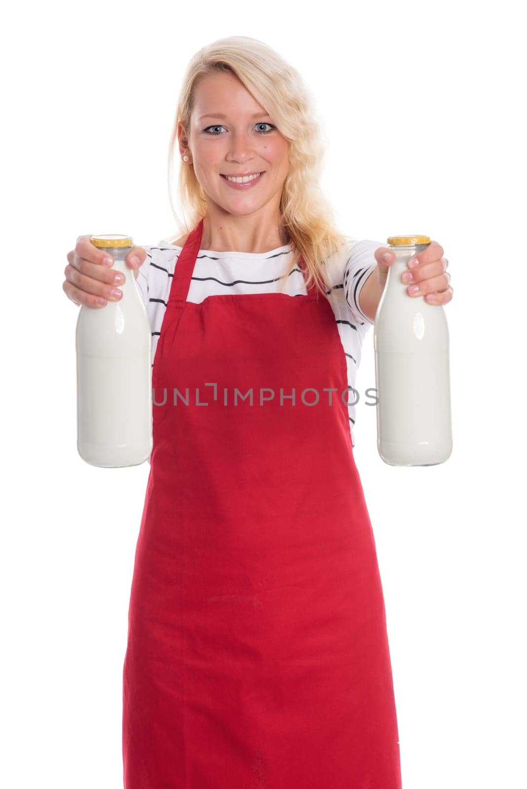 Housewife in red apron holds two bottles of milk