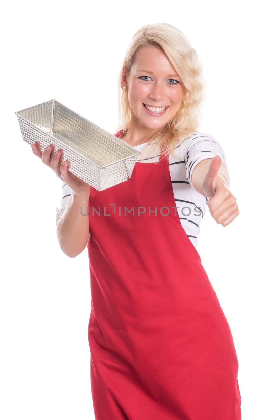 Housewife with apron holds a cake tin made of metal