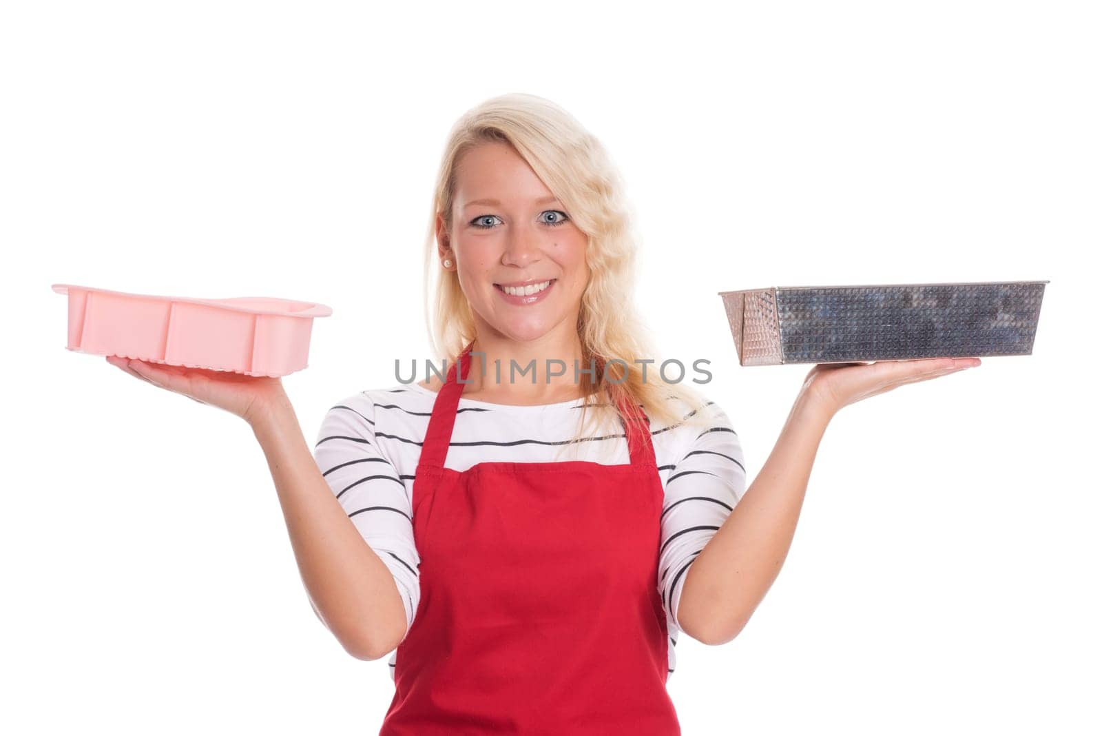 Housewife in kitchen apron keeps various baking tins