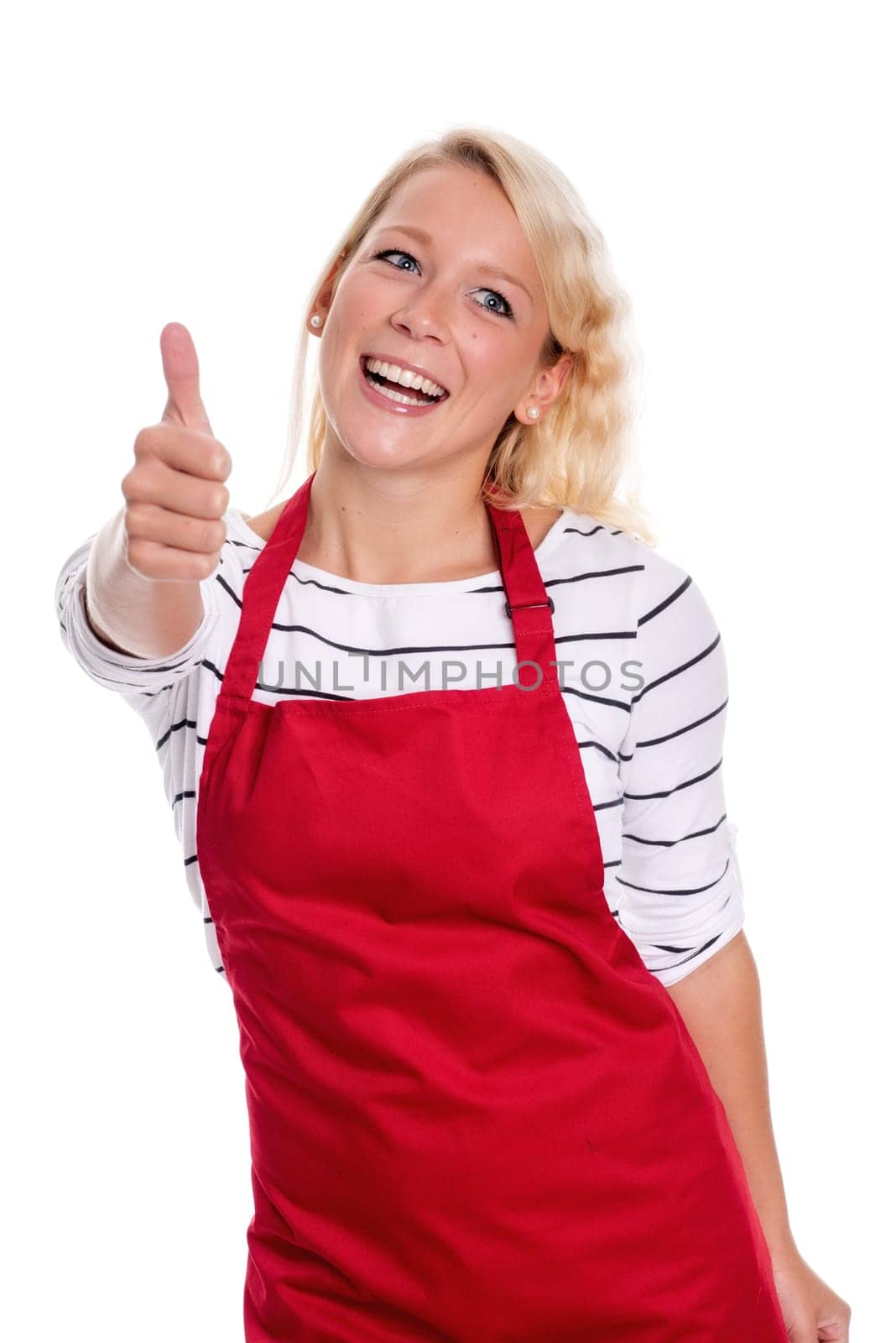 Housewife in red kitchen apron is cheerful and shows thumbs up