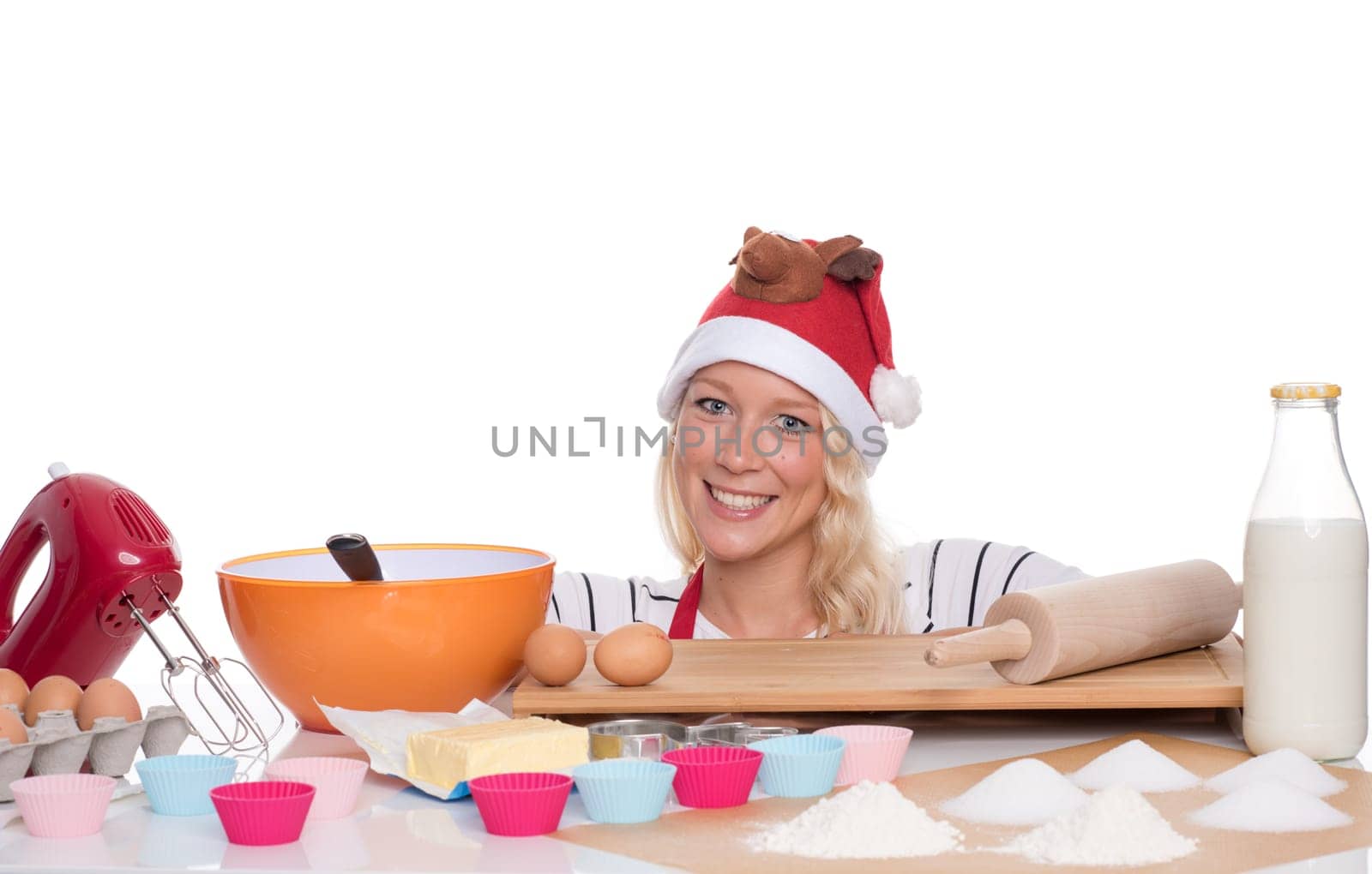 Woman with Christmas hat bakes muffins