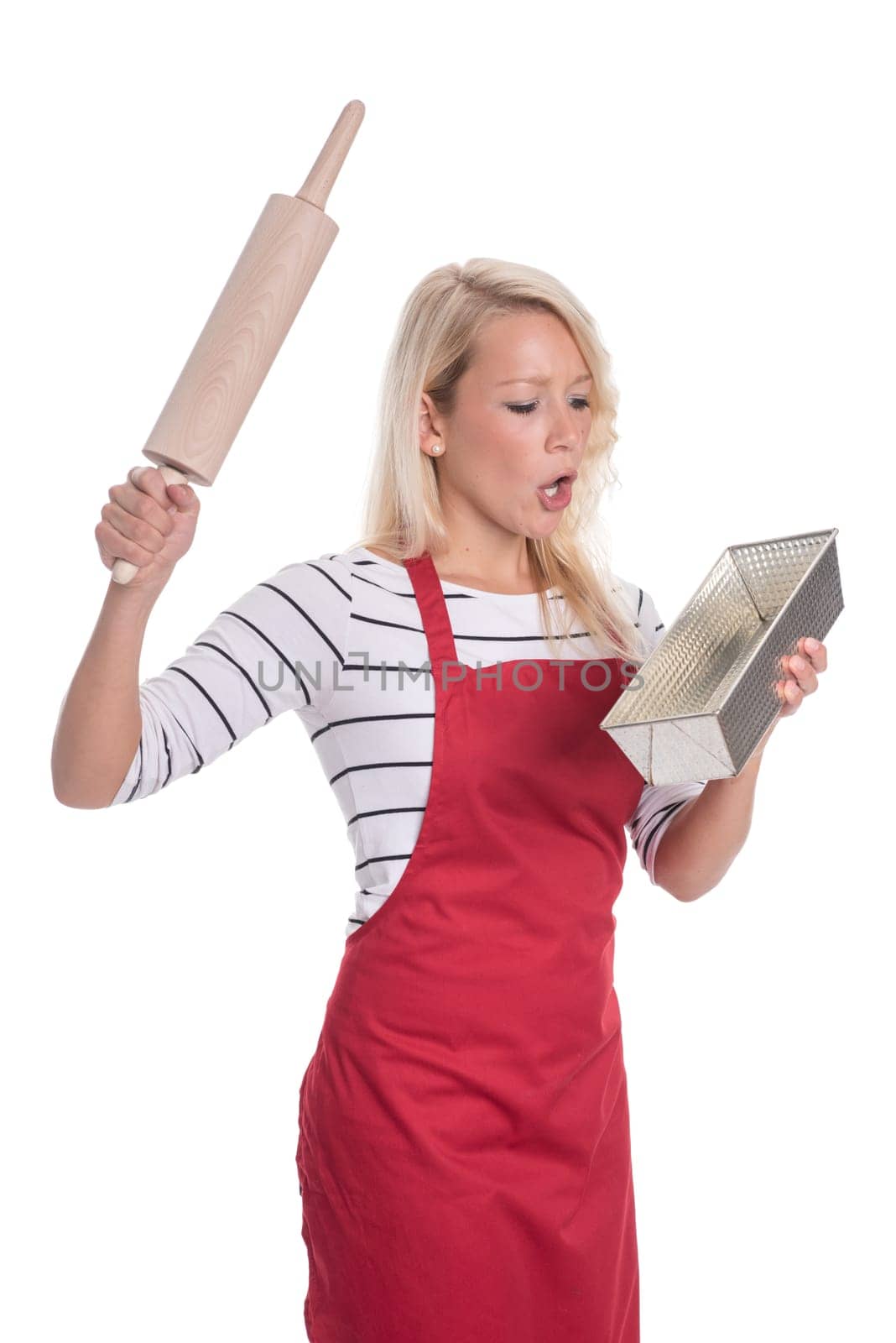 Astonished housewife with baking tin and rolling pin
