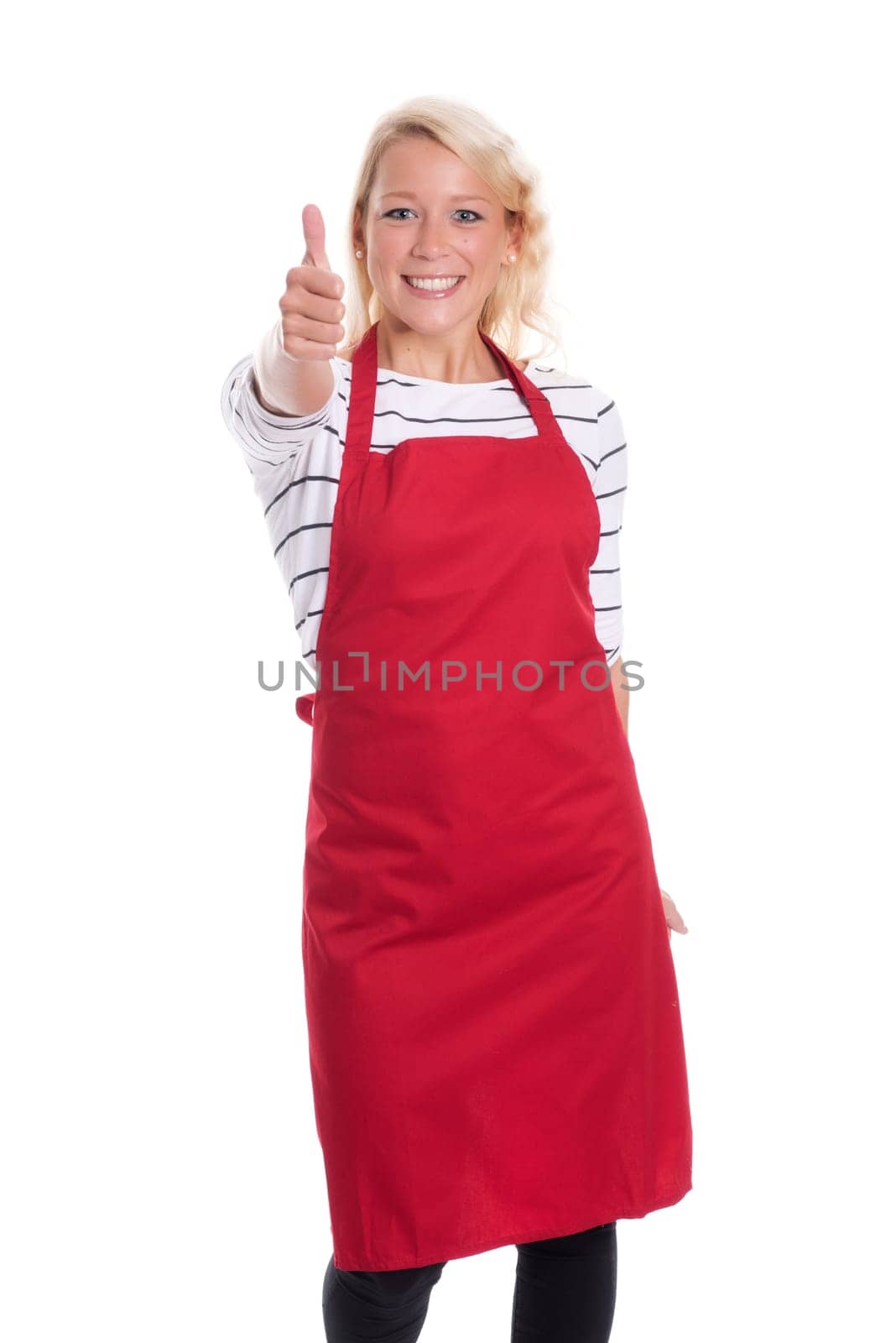 Housewife in red kitchen apron is cheerful and shows thumbs up