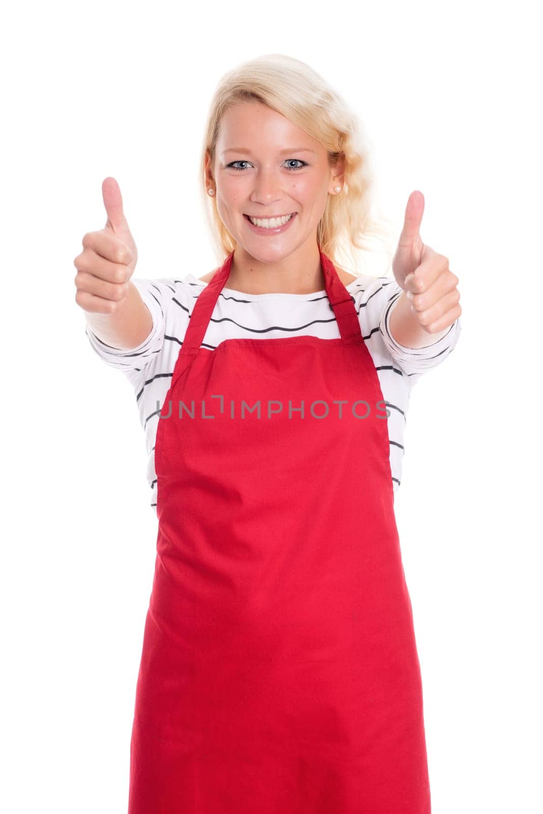Housewife in red kitchen apron is cheerful and shows thumbs up