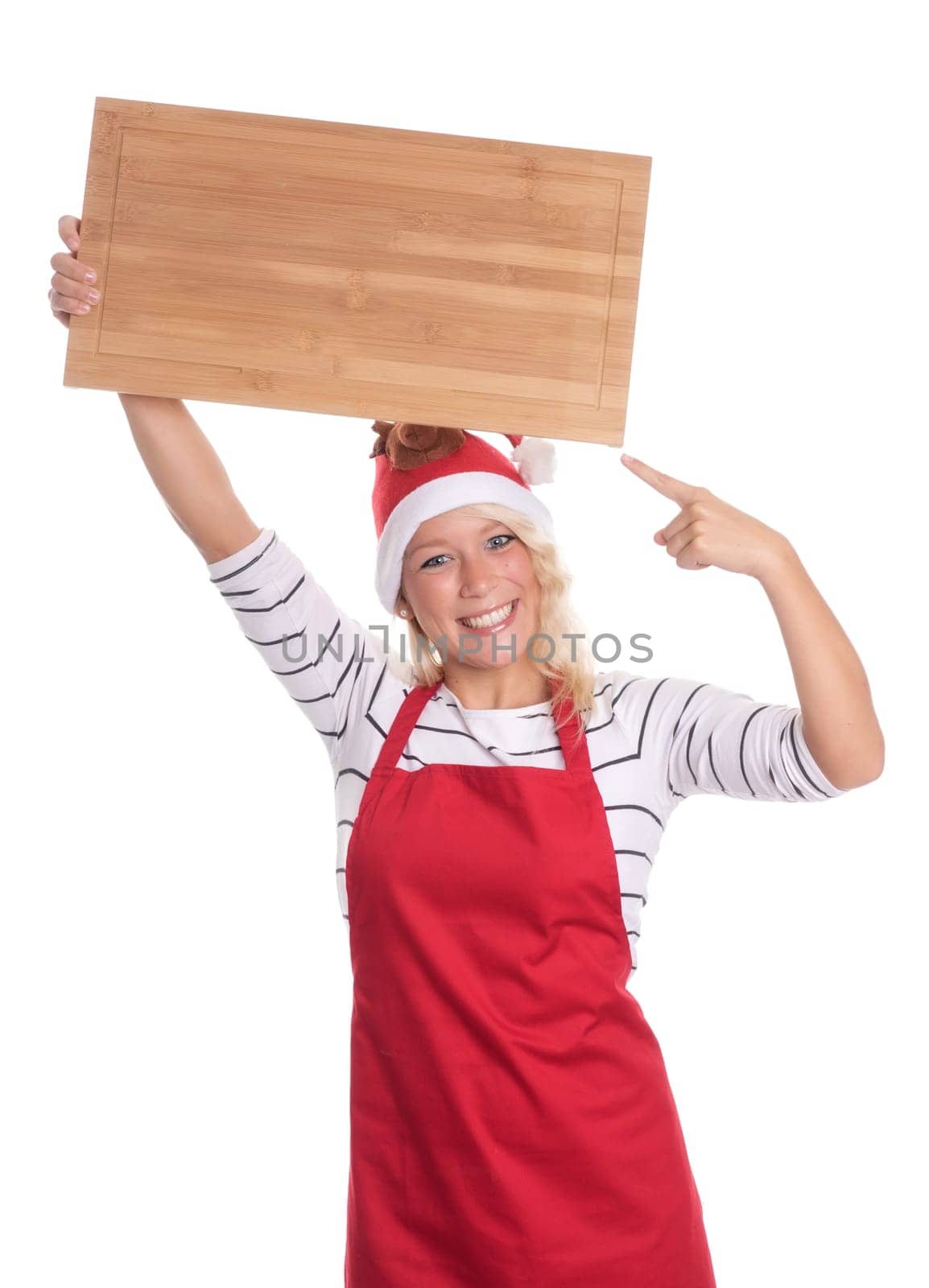 Christmas woman in apron points to a wooden board