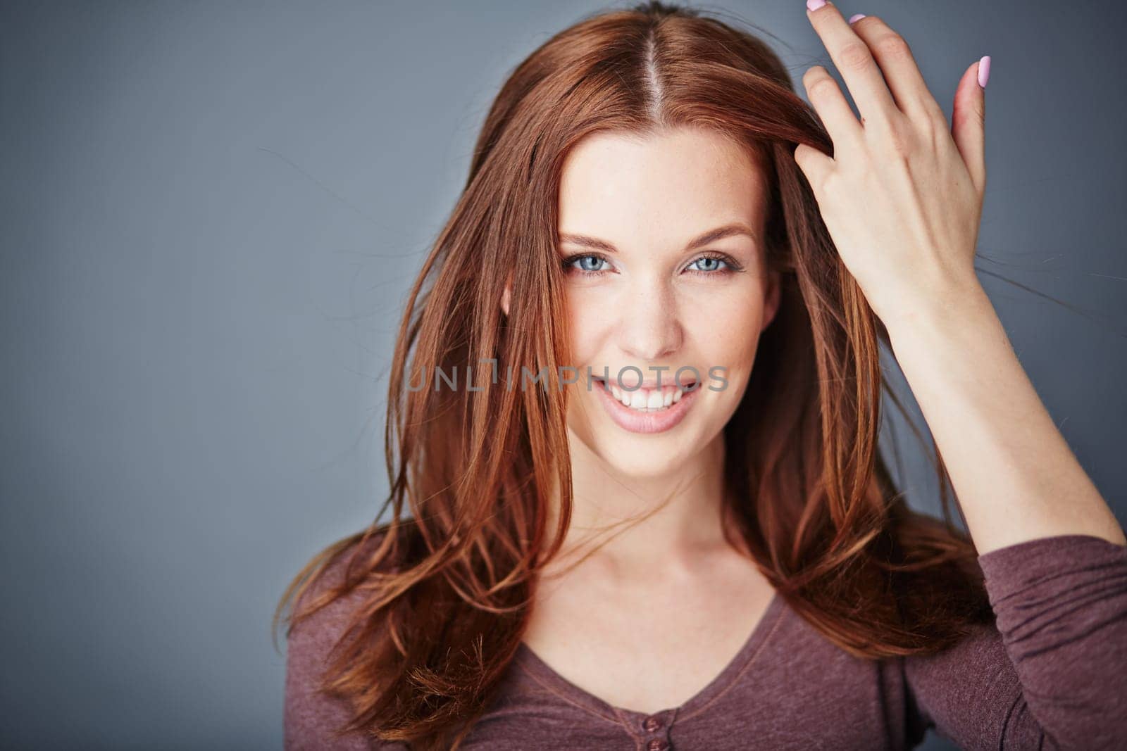Young woman with long hair looking at camera with smile