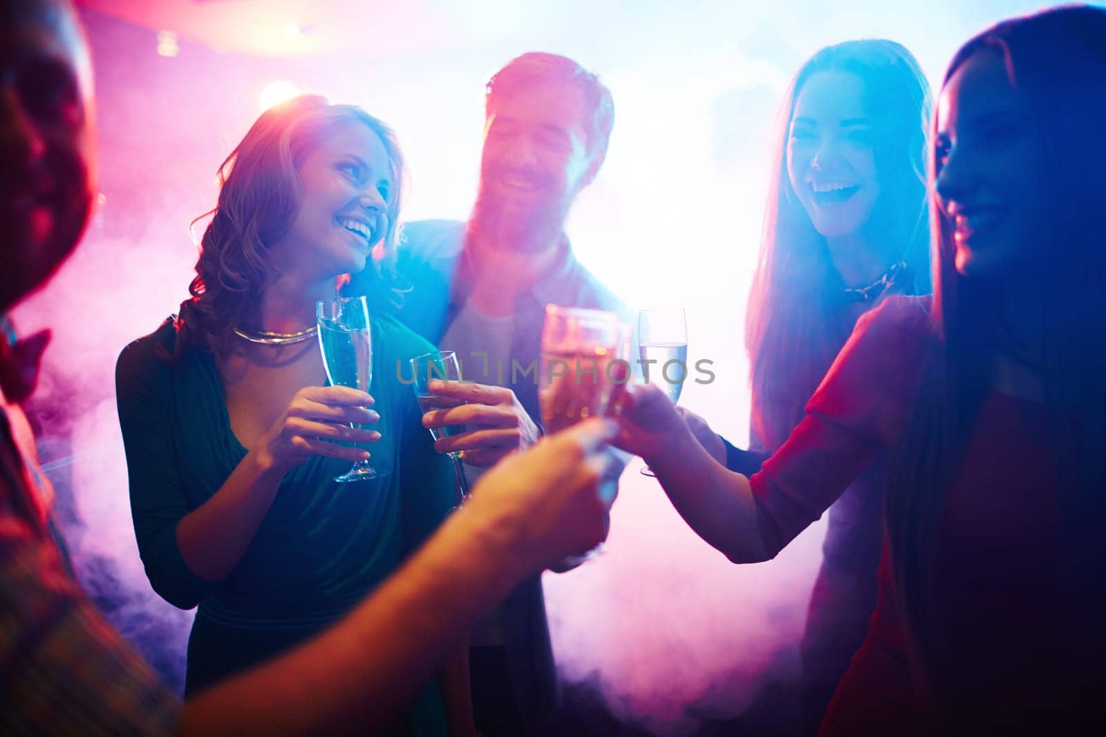 Group of happy friends with champagne having fun at party
