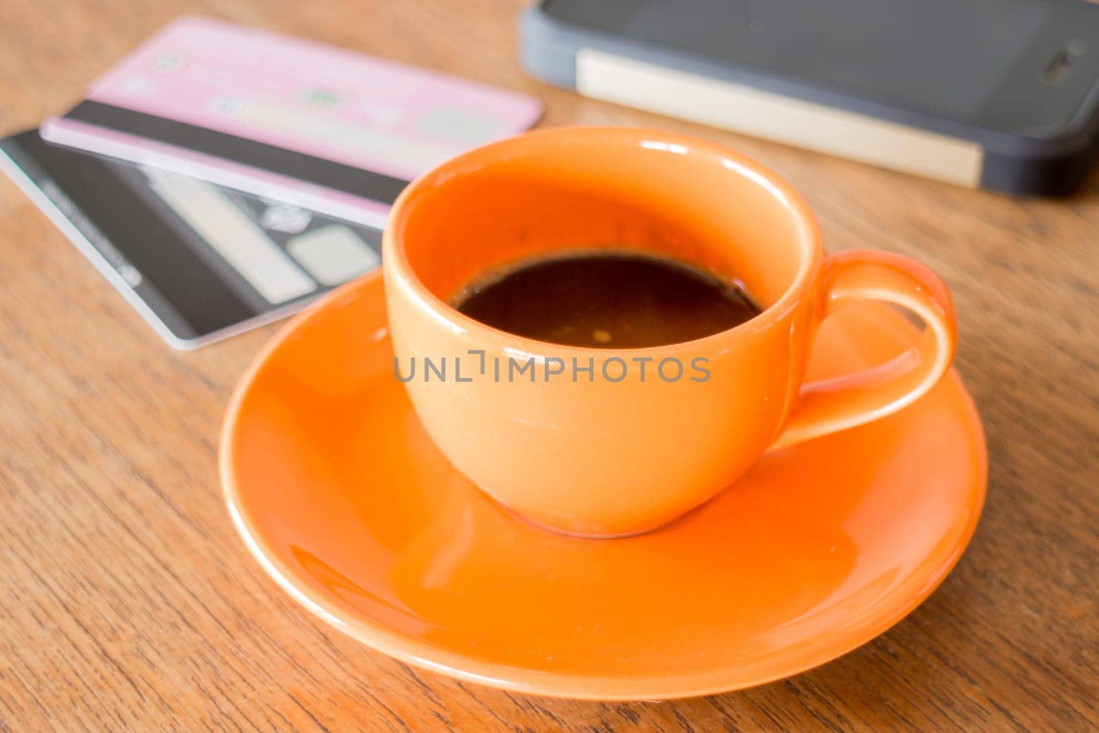 Hot coffee cup on wooden table, stock photo