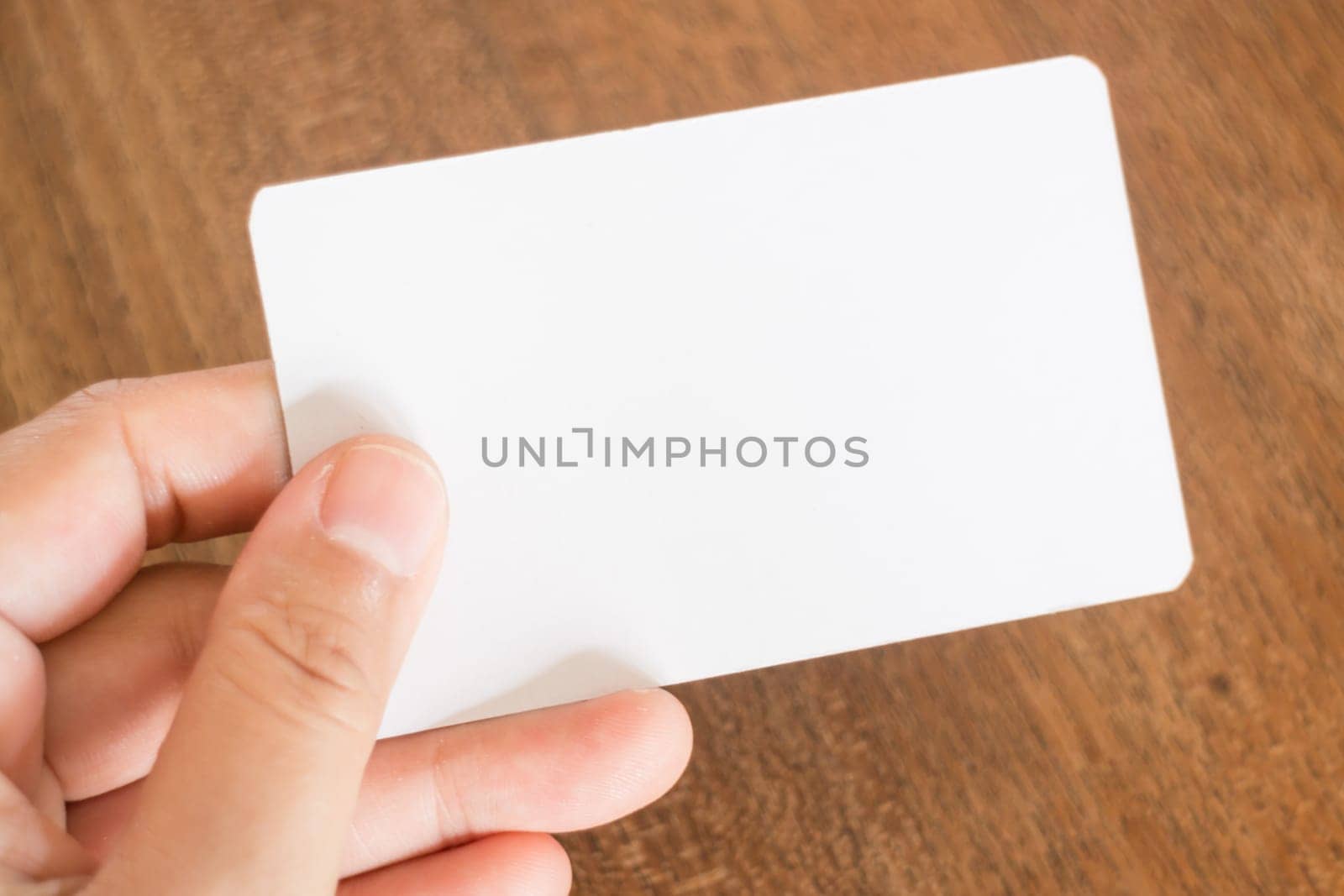 Hand holding a business card, stock photo